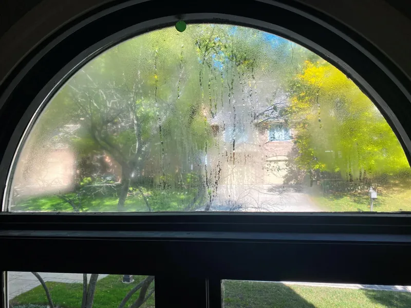 Fog and condensation between the panes of an arched double-pane window