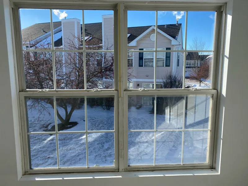 The same double-hung windows with new clear glass units after repair