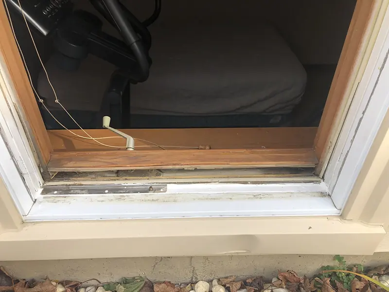Window opening with the sash out and the rotted sill exposed