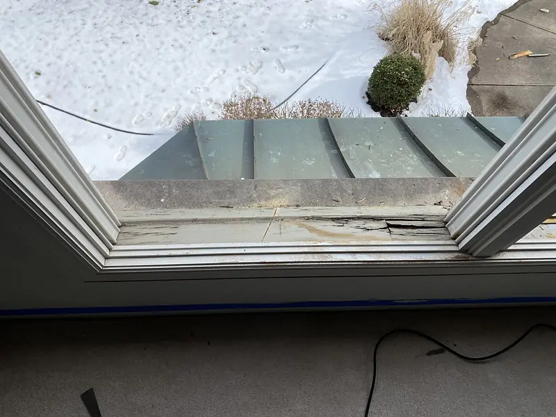 Bay window seat board with rotted wood removed, before the rebuild