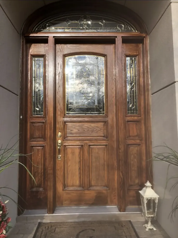 Wooden entry door with sidelites and a transom window
