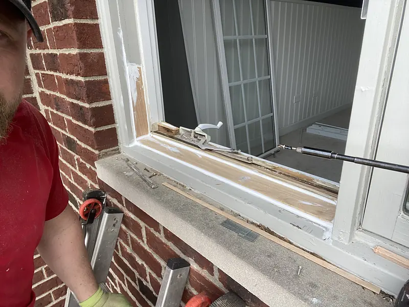 Our technician rebuilding a window sill on a brick home